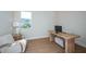 Bright home office features a minimalist design with a modern desk, comfortable seating, and a window that provides natural light at 237 Vistera Blvd, North Venice, FL 34275