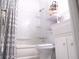 A cozy bathroom featuring a shower-tub combination with decorative gray and white curtains at 4154 57Th N St # 272, Kenneth City, FL 33709