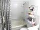 A clean bathroom featuring a shower-tub combination, decoratively adorned with flowers and towels at 4154 57Th N St # 272, Kenneth City, FL 33709