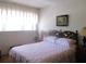 Bright bedroom with a decorative headboard, soft bedding, and large window at 4154 57Th N St # 272, Kenneth City, FL 33709