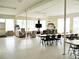 Spacious community room with multiple seating areas, tables, and a flat-screen TV at 4154 57Th N St # 272, Kenneth City, FL 33709
