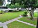 Expansive courtyard with lush lawn, mature trees, and sidewalks for residents at 4154 57Th N St # 272, Kenneth City, FL 33709