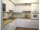 Well-maintained kitchen with white cabinetry and lots of natural light from the window at 4154 57Th N St # 272, Kenneth City, FL 33709
