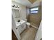 Bathroom featuring tiled shower with window and modern vanity at 5552 Pentail Cir, Tampa, FL 33625