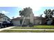Exterior view of house featuring a manicured lawn, driveway, and attached garage at 5552 Pentail Cir, Tampa, FL 33625
