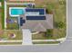Aerial view of a home highlighting its pool, deck, solar panels, landscaping, and architectural design at 567 Whippoorwill Dr, Venice, FL 34293