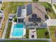 This aerial view showcases a home with a pool, deck, solar panels, and meticulously landscaped yard at 567 Whippoorwill Dr, Venice, FL 34293