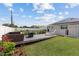 The backyard features a deck, lounge furniture, a new lawn, privacy fence, and access to the in-ground pool at 567 Whippoorwill Dr, Venice, FL 34293