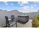 Backyard deck with comfortable chairs and a hot tub next to the fenced in perimeter at 567 Whippoorwill Dr, Venice, FL 34293