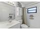 Clean, white bathroom with a shower and mirrored vanity at 567 Whippoorwill Dr, Venice, FL 34293