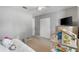 This bedroom offers neutral walls, a comfy bed, a closet, and a TV, ideal for relaxation and entertainment at 567 Whippoorwill Dr, Venice, FL 34293