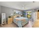 Cozy bedroom with natural light, ceiling fan, and serene gray wall color at 567 Whippoorwill Dr, Venice, FL 34293
