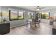 Well-lit dining room with three large windows and neutral decor at 567 Whippoorwill Dr, Venice, FL 34293