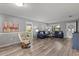 Inviting living area featuring laminate flooring, comfortable sofas, and a relaxing atmosphere at 567 Whippoorwill Dr, Venice, FL 34293