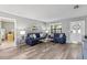 Bright living room with laminate flooring, cozy blue sofas, and stylish decor at 567 Whippoorwill Dr, Venice, FL 34293