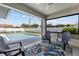 Covered patio area with poolside seating and view of the fenced-in pool in the backyard at 567 Whippoorwill Dr, Venice, FL 34293