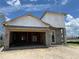 An unfinished single Gathering home showing exterior elevation of the construction with an open garage at 7979 Chandler Lake Ct, Hudson, FL 34667