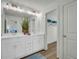 Modern bathroom with double sinks, quartz countertops, and ample storage at 13964 Emerald Fields Dr, Hudson, FL 34667