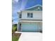 New two-story townhome with two-car garage and landscaped front yard at 13964 Emerald Fields Dr, Hudson, FL 34667