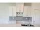 Kitchen with white cabinets, stainless steel appliances, subway tile backsplash, and quartz countertops at 13964 Emerald Fields Dr, Hudson, FL 34667