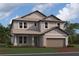 Charming two-story home with a two-car garage and beautifully manicured lawn at 17106 Savory Mist Cir, Lakewood Ranch, FL 34211