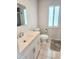 Bright bathroom with a vanity sink, modern fixtures, and a window at 22481 Westchester Blvd # A19, Punta Gorda, FL 33980