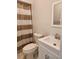 Cozy bathroom featuring a sink and toilet with a shower and striped curtain at 22481 Westchester Blvd # A19, Punta Gorda, FL 33980