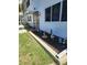 Exterior view of a home with a well-maintained lawn, flower bed, and charming details at 22481 Westchester Blvd # A19, Punta Gorda, FL 33980