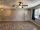 Spacious living room with tile flooring, ceiling fan, and bright natural light at 22481 Westchester Blvd # A19, Punta Gorda, FL 33980