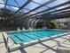A beautifully enclosed community pool, perfect for year-round swimming and relaxation, with several poolside chairs at 22481 Westchester Blvd # A19, Punta Gorda, FL 33980