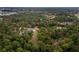 Aerial view of a house surrounded by lush green trees, featuring a pool and river frontage at 233 Snyder Dr, Venice, FL 34292