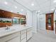 Bright bathroom featuring double vanity, wood paneled accent wall, and modern finishes at 233 Snyder Dr, Venice, FL 34292