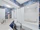 Stylish bathroom features a shower-tub, vanity, and blue floral wallpaper for a unique and eye-catching design at 233 Snyder Dr, Venice, FL 34292