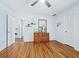 Open bedroom with hardwood floors, mirror, and modern decor at 233 Snyder Dr, Venice, FL 34292