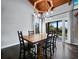 Dining room features dark wood floors, dining table, and doors that lead to the outside at 233 Snyder Dr, Venice, FL 34292