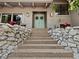 Charming home entry with a stone wall, steps leading to a serene, light blue double door at 233 Snyder Dr, Venice, FL 34292