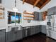 Kitchen features gray cabinetry, stainless appliances, and a large window with backyard views at 233 Snyder Dr, Venice, FL 34292