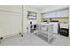 Functional laundry room with ample storage, washer, dryer, and a folding table at 233 Snyder Dr, Venice, FL 34292