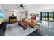 Open-concept living room with a piano, comfortable seating, and a large window with lake views at 233 Snyder Dr, Venice, FL 34292
