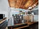 Open concept living space with vaulted wood ceiling and dining area with a bar and lots of light at 233 Snyder Dr, Venice, FL 34292