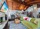 Spacious living room with vaulted wood ceilings, stone fireplace, and comfortable green seating at 233 Snyder Dr, Venice, FL 34292