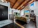Open-concept living area featuring wood floors, a stone fireplace, and vaulted wood ceilings at 233 Snyder Dr, Venice, FL 34292