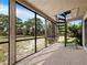 Screened-in patio featuring a unique spiral staircase, offering an outdoor living space at 233 Snyder Dr, Venice, FL 34292