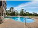 Beautiful pool with unique rounded shape and a custom-built stone wall border adding great character at 233 Snyder Dr, Venice, FL 34292