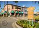 Picturesque view of a shopping district with colorful buildings, street signs and lush landscaping at 233 Snyder Dr, Venice, FL 34292