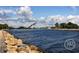 Scenic view of a waterfront with rocky shoreline, enhancing the property's coastal appeal at 233 Snyder Dr, Venice, FL 34292