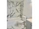 Bathroom featuring a tub with modern marble tile, gray vanity, and modern gray flooring at 4934 Avery Rd, New Port Richey, FL 34652