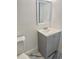 Bathroom featuring a gray vanity, modern gray flooring, and crisp white walls at 4934 Avery Rd, New Port Richey, FL 34652
