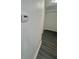 Hallway with wood flooring and thermostat at 4934 Avery Rd, New Port Richey, FL 34652