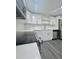 Bright kitchen featuring white cabinets, stainless steel appliances, and modern light-colored flooring at 4934 Avery Rd, New Port Richey, FL 34652